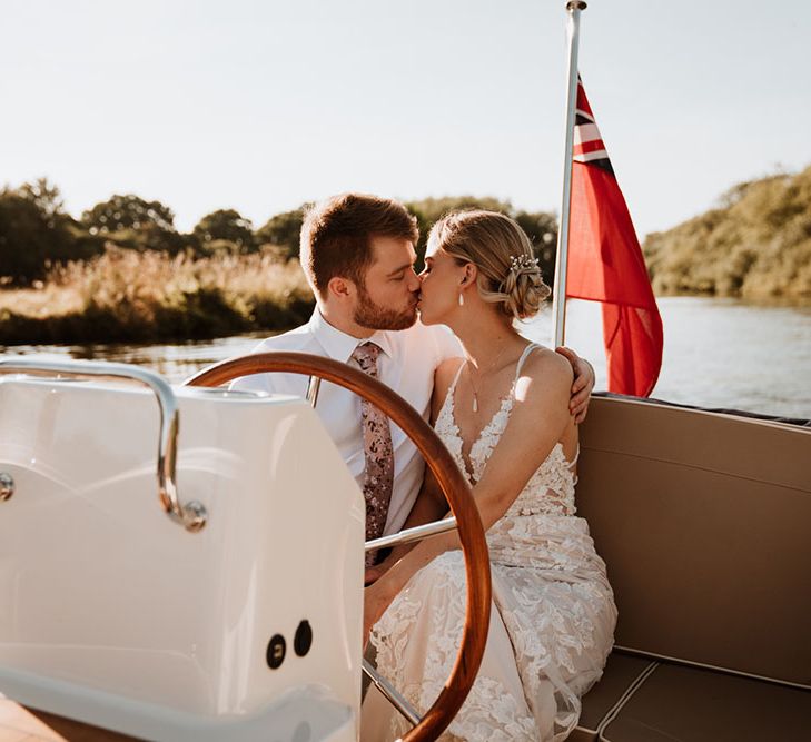 Bride & groom during boat ride across the Thames after outdoor humanist wedding ceremony 