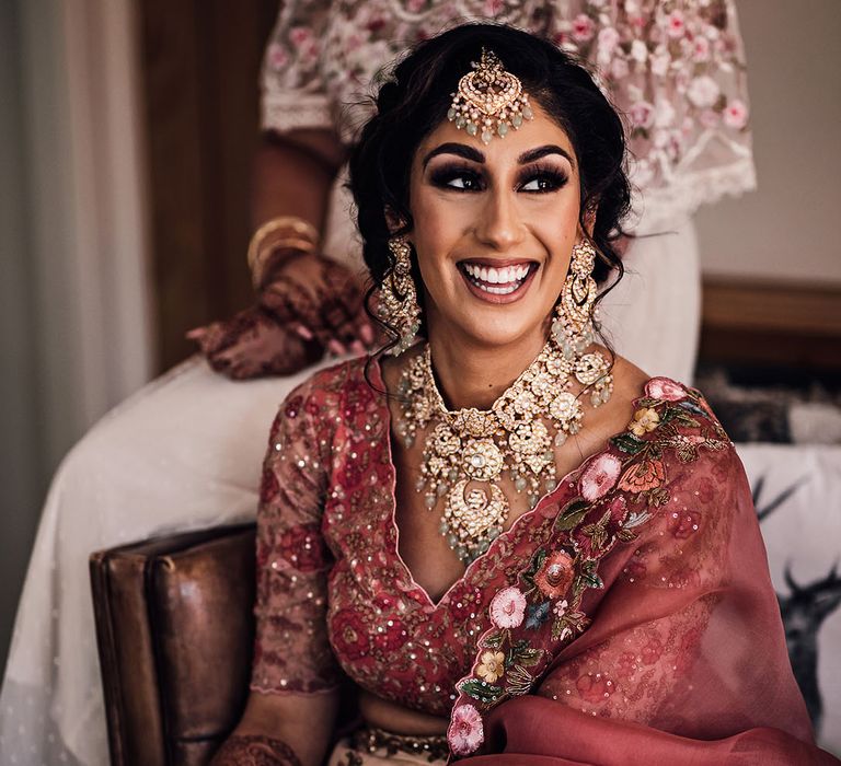 Bride wears beautifully embellished floral lehenga and bold jewellery