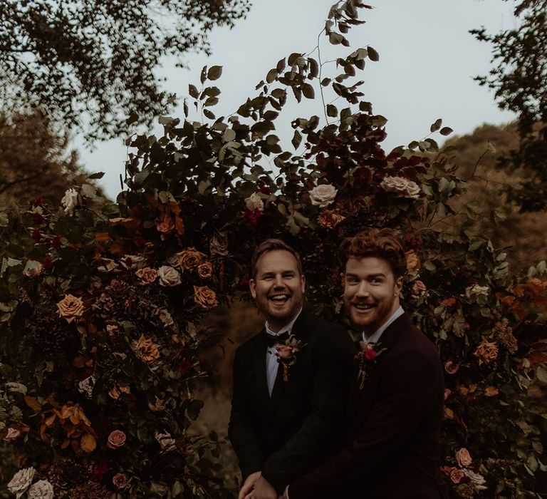 Grooms cute their simple two tier rustic wedding cake together 