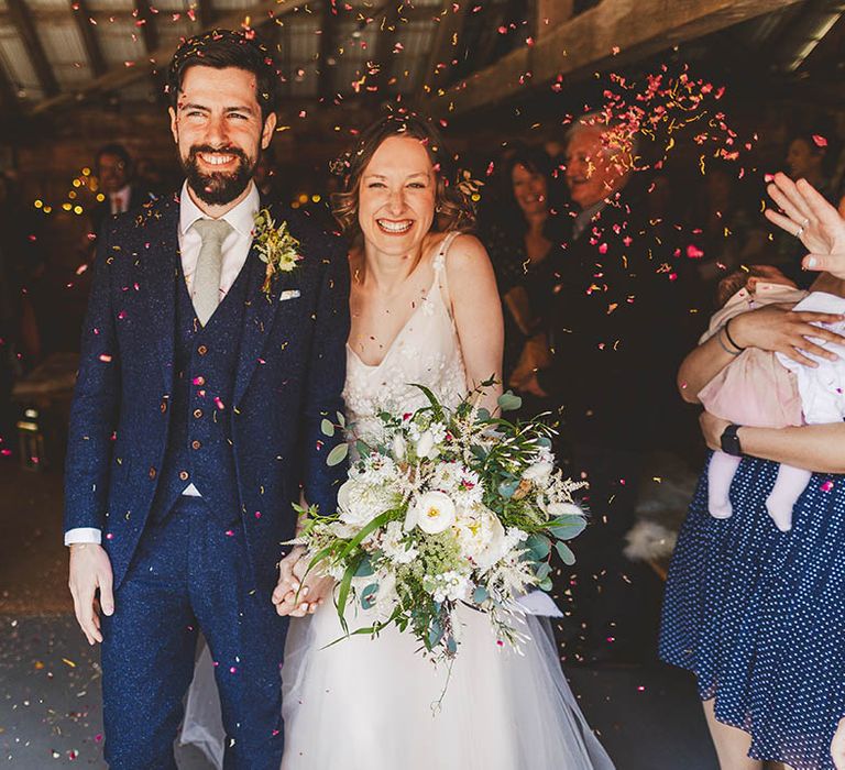 Win wedding photography with We Are // The Clarkes and get fun wedding photos like this bride and Groom confetti shot