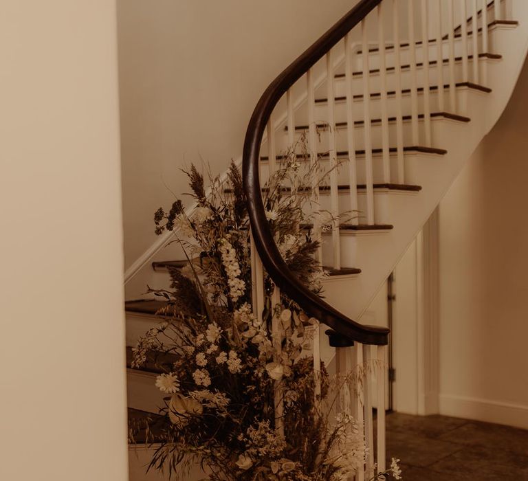 Boho wedding with neutral wedding flower arrangement on the staircase 