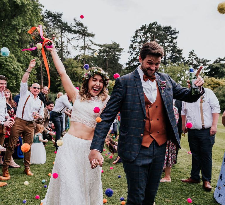 Bride wears tank top styled crop top with embellished full skirt for festival wedding 