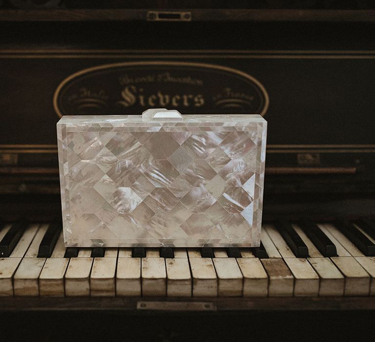 Silver bridal clutch on vintage piano keys