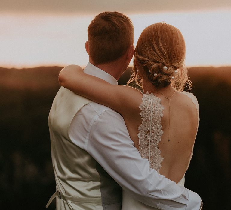 Bride wears pearl hair accessories in chignon hair style