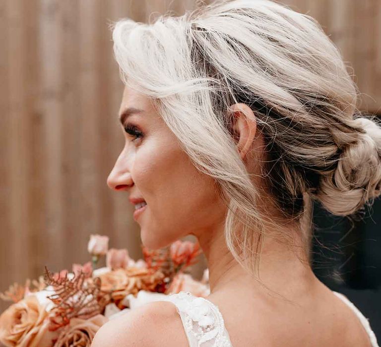 Bride sporting delicate and elegant up-do bridal hairstyle