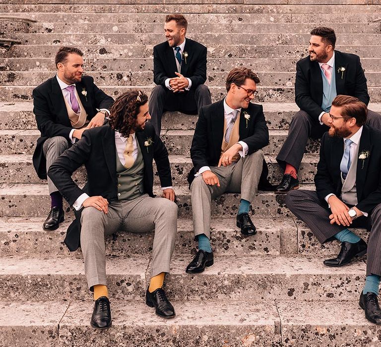 Groomsmen in morning suits with colourful tie and sock accessories for country house mansion wedding at The Grange 