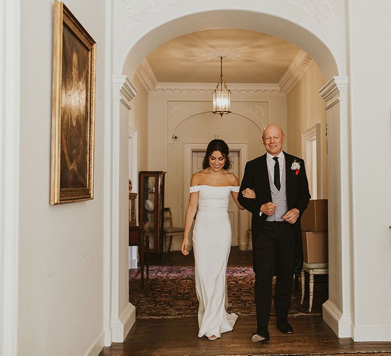 Bride in off the shoulder simple and minimalist wedding dress walking with father to the wedding | Steph Newton Photography