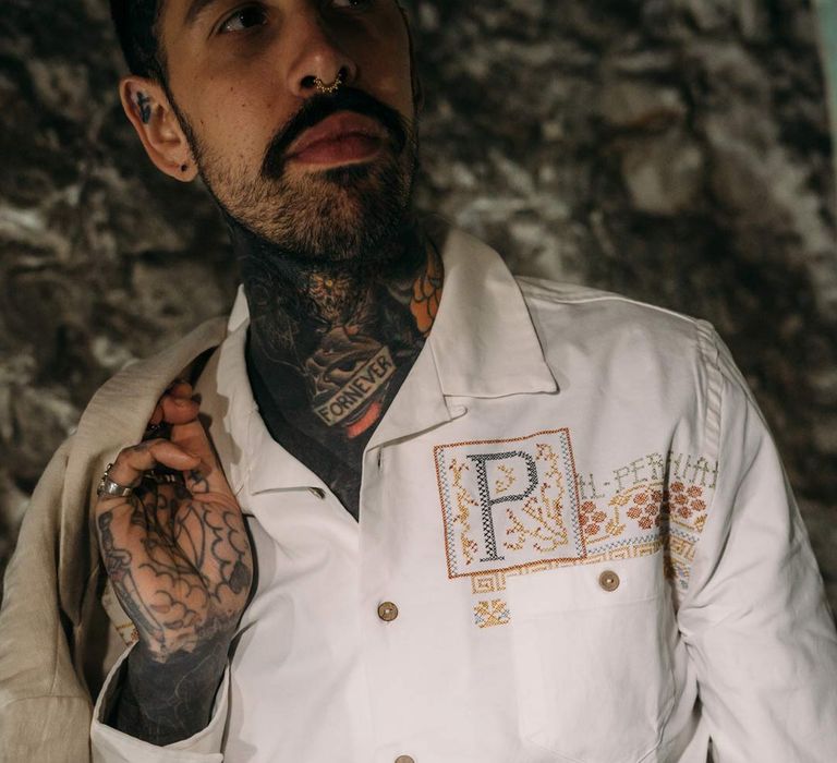 Groom in beige linen suit and embroidered linen shirt in Margate Caves