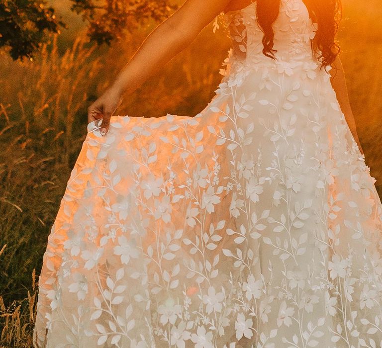 Bride in delicate floral lace wedding gown by Savin London 