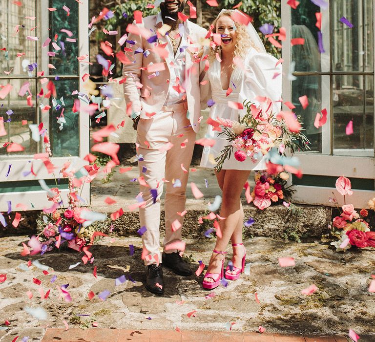 Confetti moment for bride and groom as they exit from Polstrong Manor wedding 