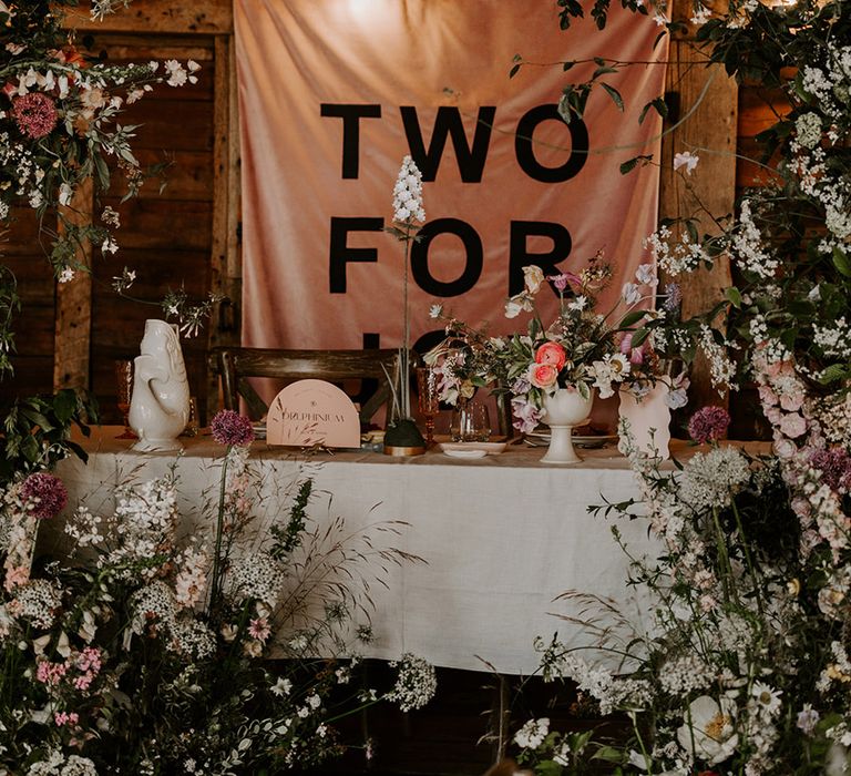 Pastel wedding theme at Preston Court with neon wedding sign, pink wedding banner sign and whimsical neutral flowers 