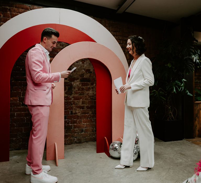 Colourful pink, red and white arches decorate the altar at The Shack Revolution wedding venue 