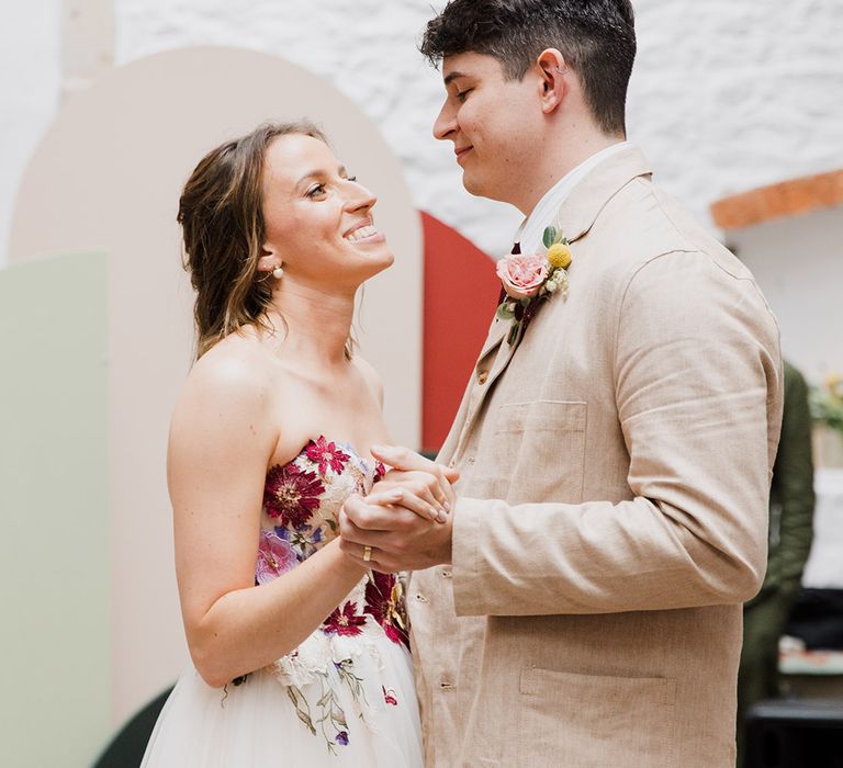 The bride and groom share their first dance together 