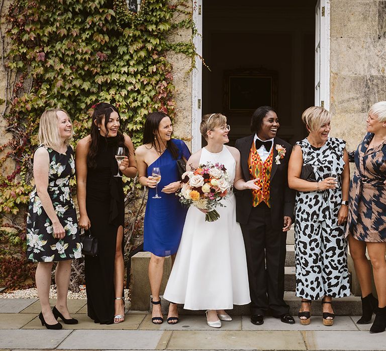 Wedding guests pose with the two brides at Bowcliffe Hall 