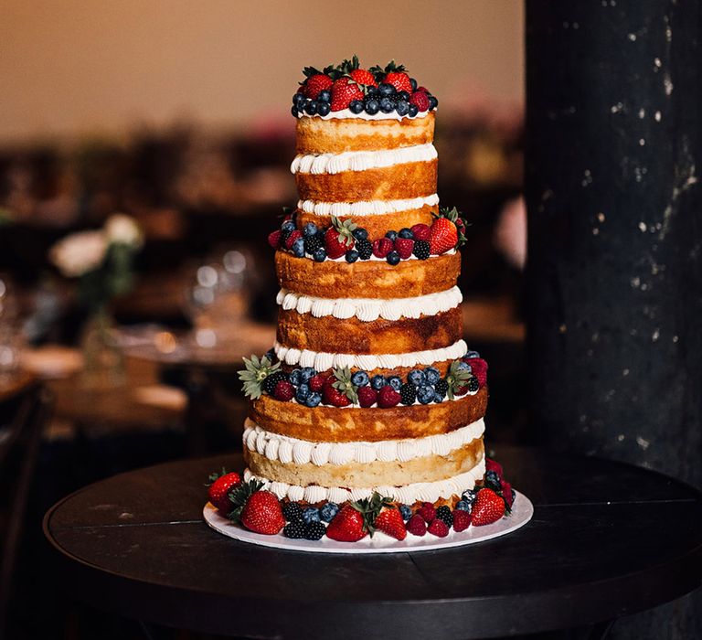 Semi naked wedding cake with berries for city wedding 