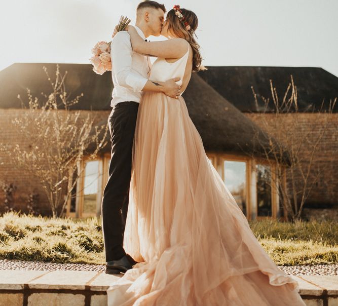 Dramatic Wedding Day Photo with Newly-wed couple kissing in the countryside at Brickhouse Vineyard