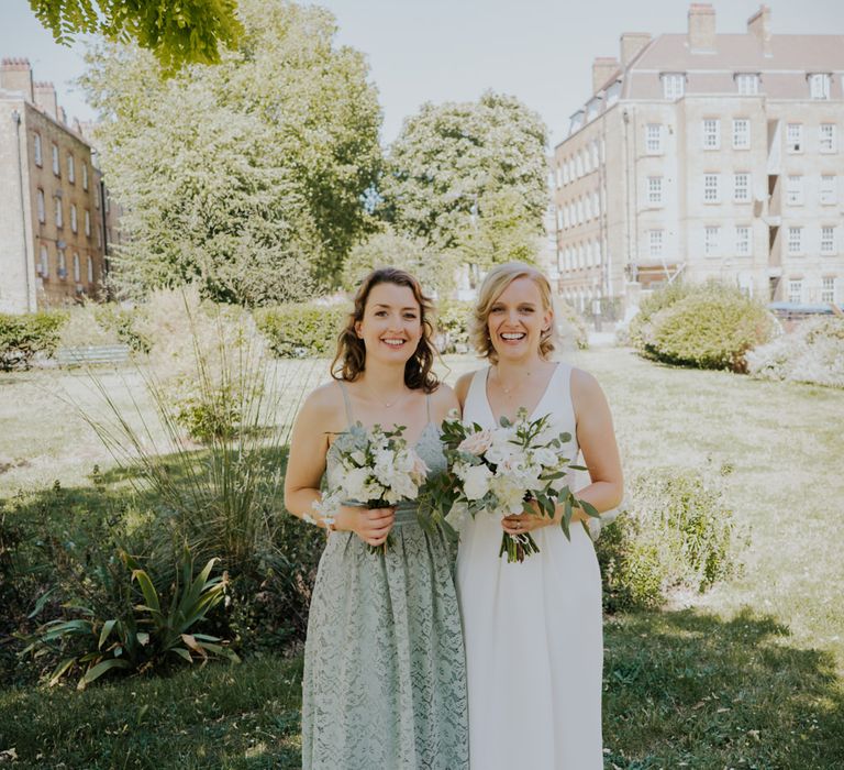 Bride in White by Vera Wang wedding dress and bridesmaid in lace dress