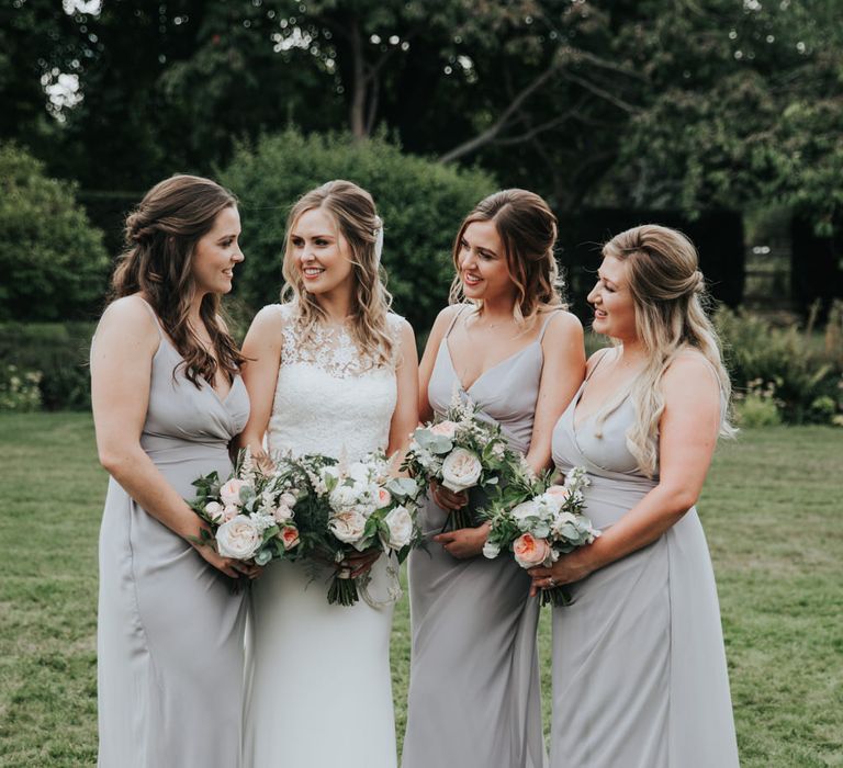 Bridal party portrait with bridesmaids in light grey dresses 