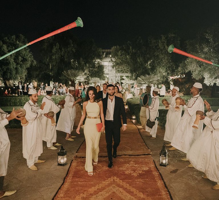 Wedding guests arriving at Marrakech reception with Moroccan rugs