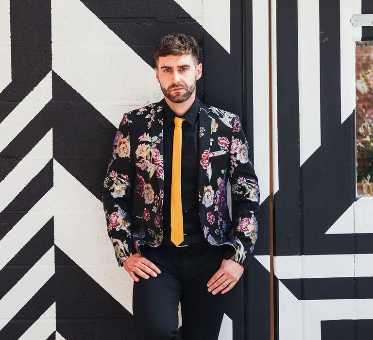 Groom in patterned blazer and yellow skinny tie