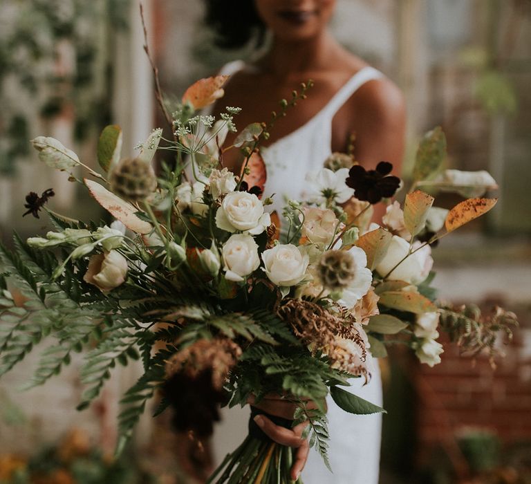 Autumn wedding bouquet with green, brown and white flowers and foliage 