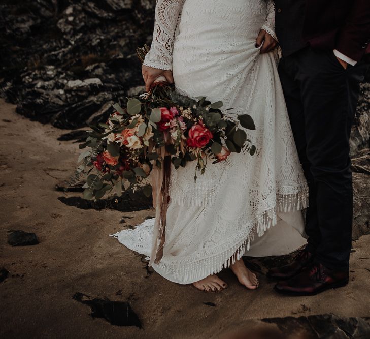 Large wedding bouquet of roses and other deep pinks and green foliage