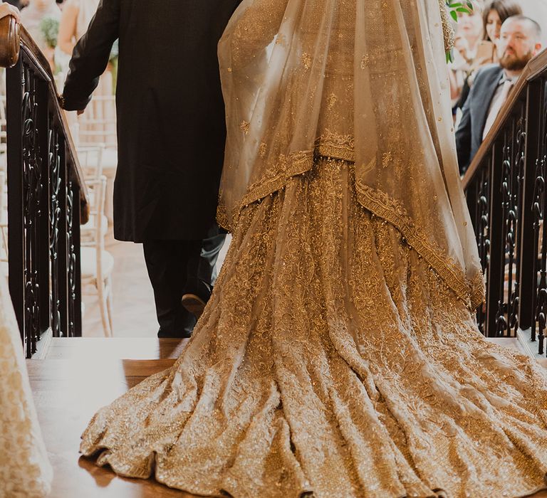 Wedding ceremony bridal entrance in gold dress and veil 