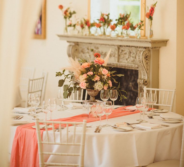 Coral and peach wedding reception table decor 