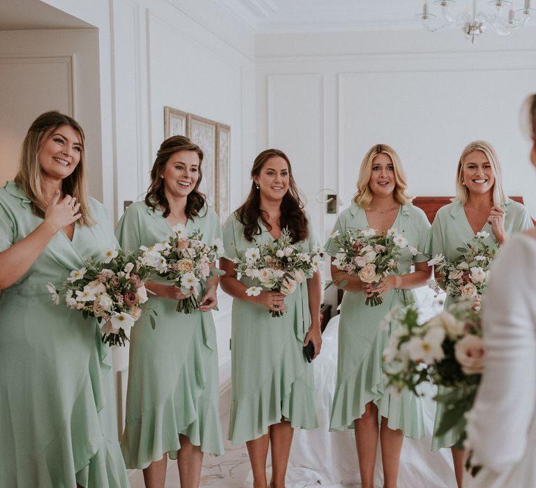 Bride reveals her wedding dress to her bridesmaids for London wedding 