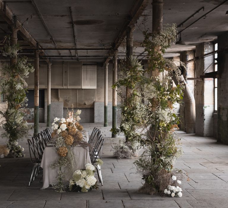 Atlas Studios industrial wedding venue decorated with green, white and dried wedding flowers 