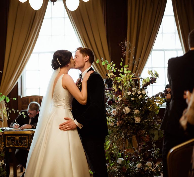 Bride and groom kissing at town hall wedding