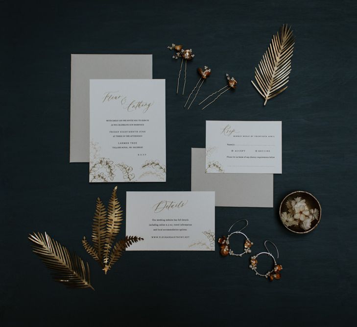 Minimal white and gold wedding stationery with floral detailing