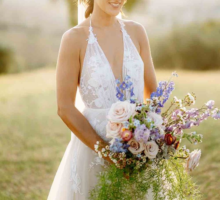 Bride in plunging halterneck dress with gorgeous oversized bouquet