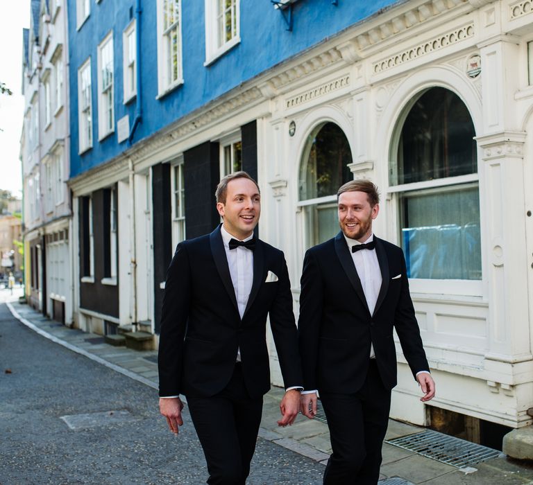 Grooms stroll through Oxford in black tuxedos on wedding day