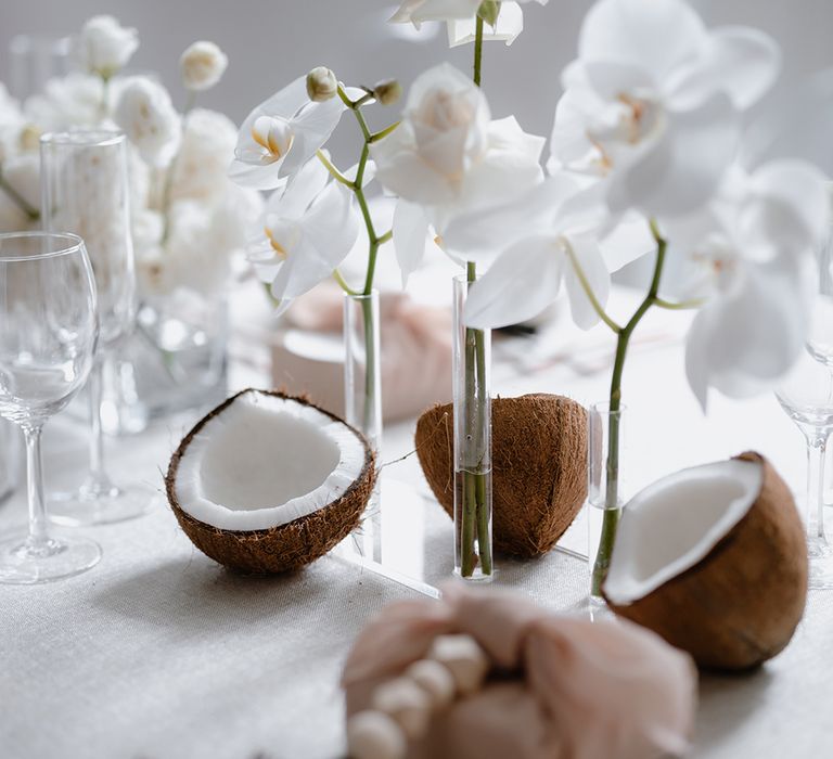 Asian Lesbian wedding table decor with coconuts and orchids 