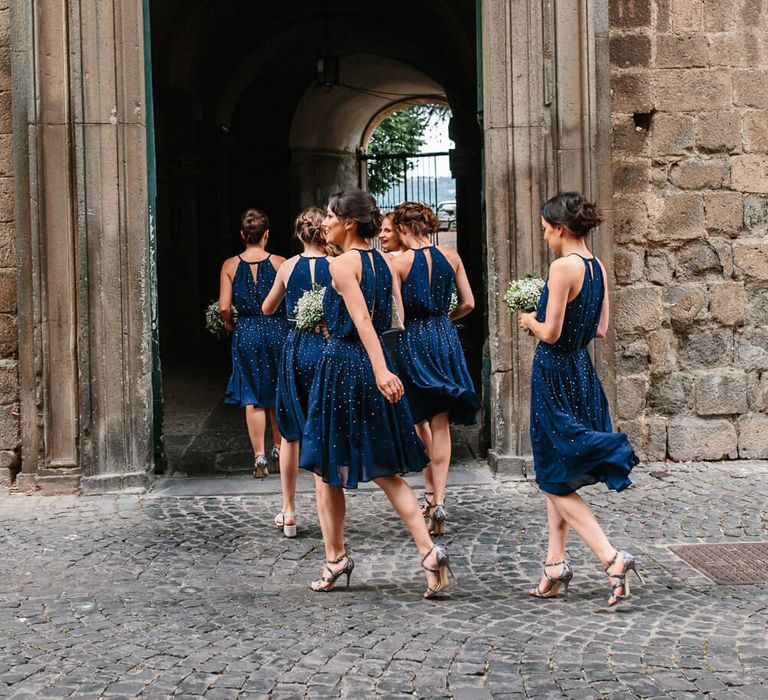 Bridesmaids wearing short, sparkly navy bridesmaid dresses with halter neck and back slit detail | French Connection Dresses | Studio A+Q Photography