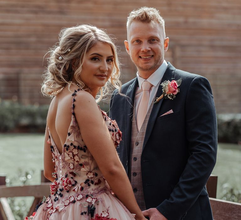 Bride & groom hold hands on their wedding day for post-wedding photoshoot