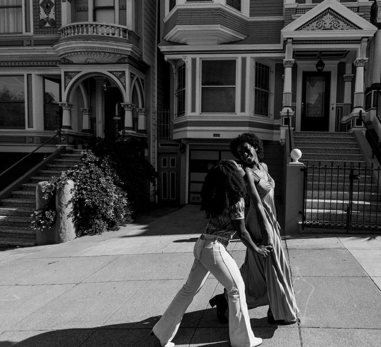 Black and white portrait of LGBTQ+ couple walking up the hills in San Francisco 