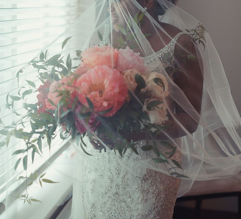 Bride wears her veil over her face on her wedding day