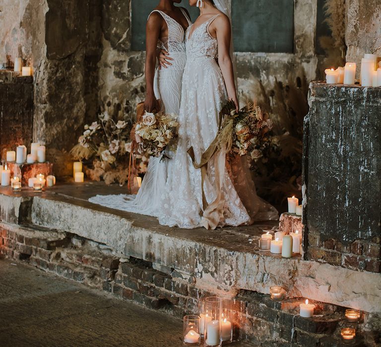 A Black couple celebrate their wedding by dancing on the dance floor. The bride wears a strapless sweetheart neckline dress and the groom wears black tie.