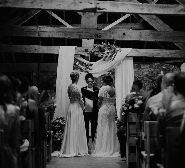 Black and white portrait of two brides at their same sex Woolas Barn wedding 