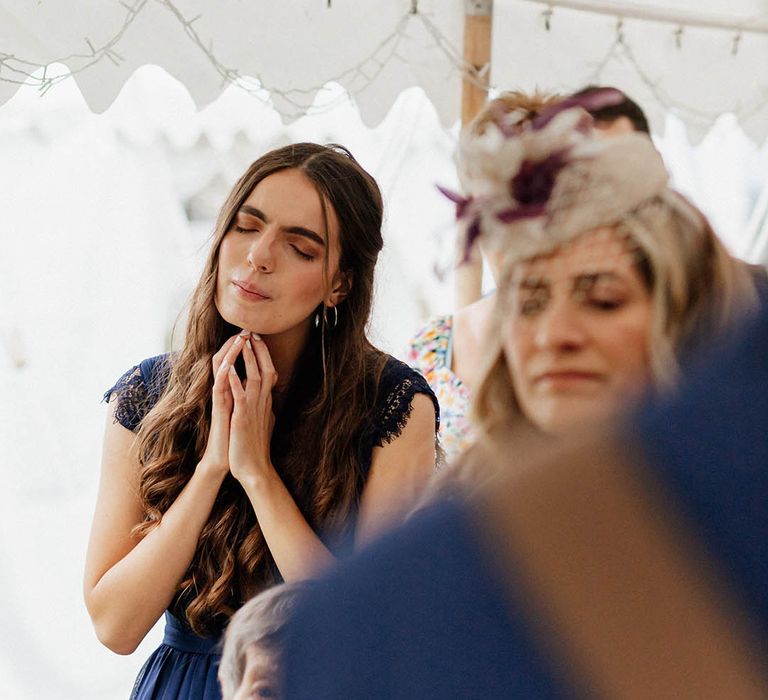 Bridesmaid looks on during wedding ceremony