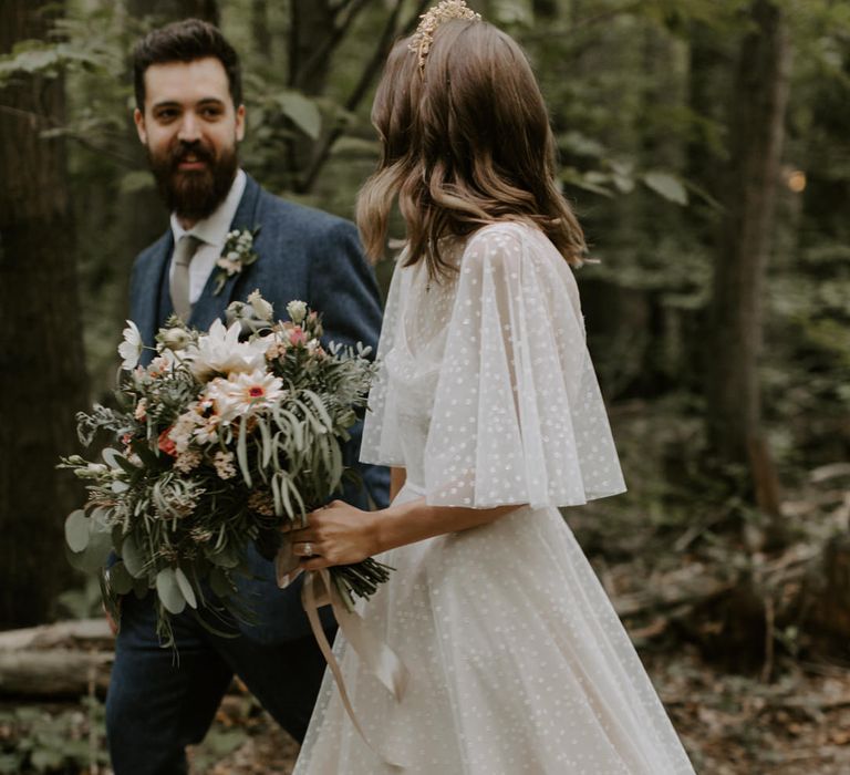 Bride walks whilst her E&W Couture wedding gown trails around her