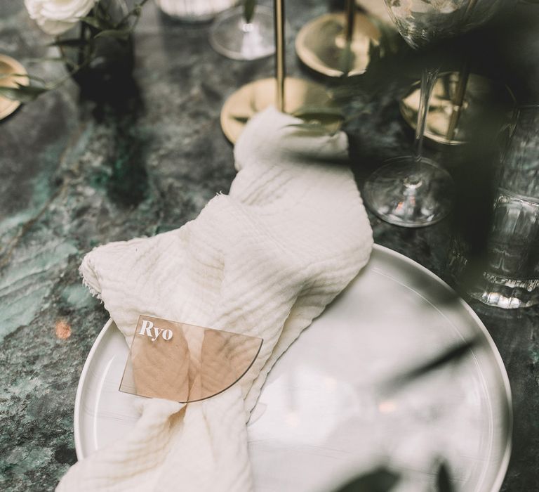 Place setting with linen napkin and acrylic name place card 