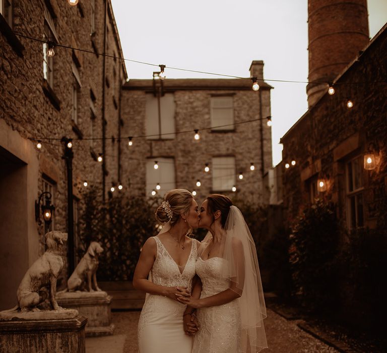 Brides kiss at Holmes Mill