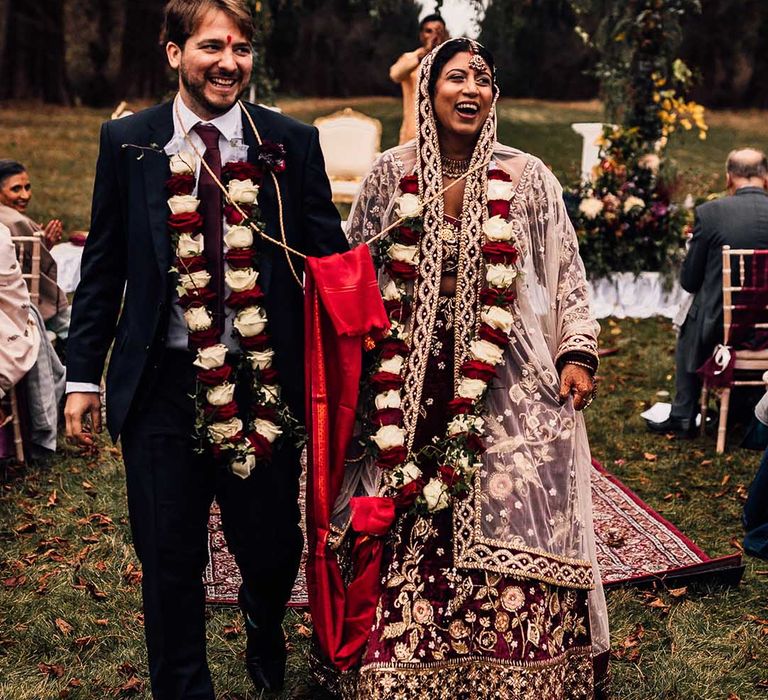 Indian wedding at Minley Manor Bride & Groom smile hand in hand