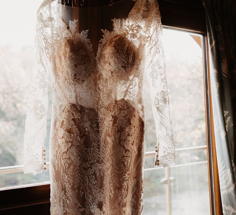 Bride's wedding dress with lace details, long sleeves and illusion neckline for winter wedding at Hidden River Barn