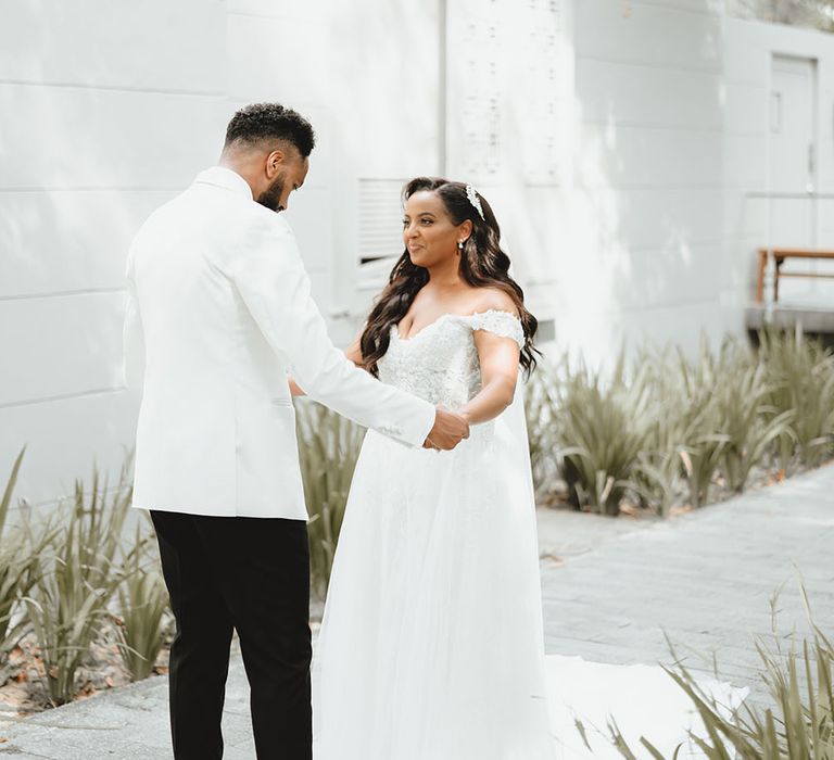 Groom sees his bride for the first time during first-look moment outdoors in Phuket 