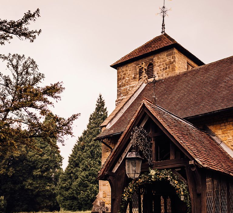 Church wedding venue decorated with yellow wedding flowers