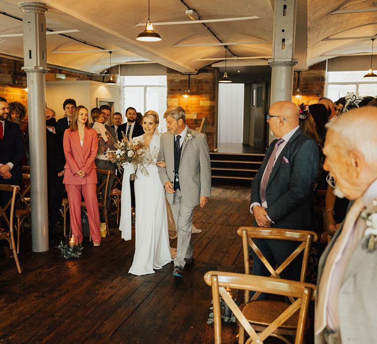 Bride walks down the aisle with her father at The Venue Bowers Mill 